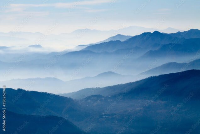 mountains in the fog. Misty mountain blue. Himalayan mountain range in uttrakhand Brahmatal.