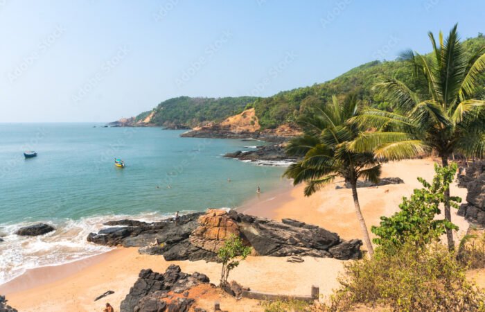 Paradise beach in Gokarna. Beautiful deserted landscape with clean sand and wave. View from the sea to the shore.